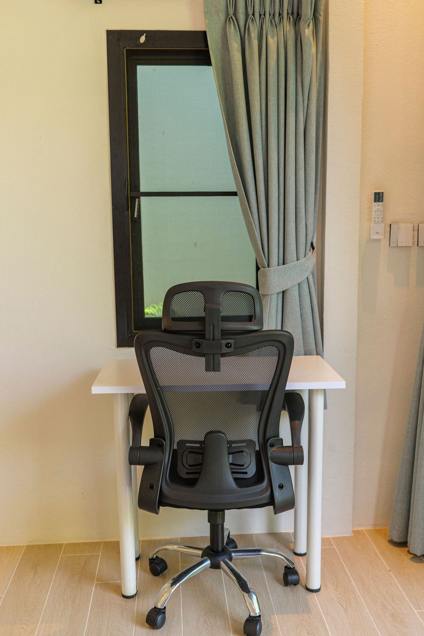 Workspace with an ergonomic mesh chair at the window