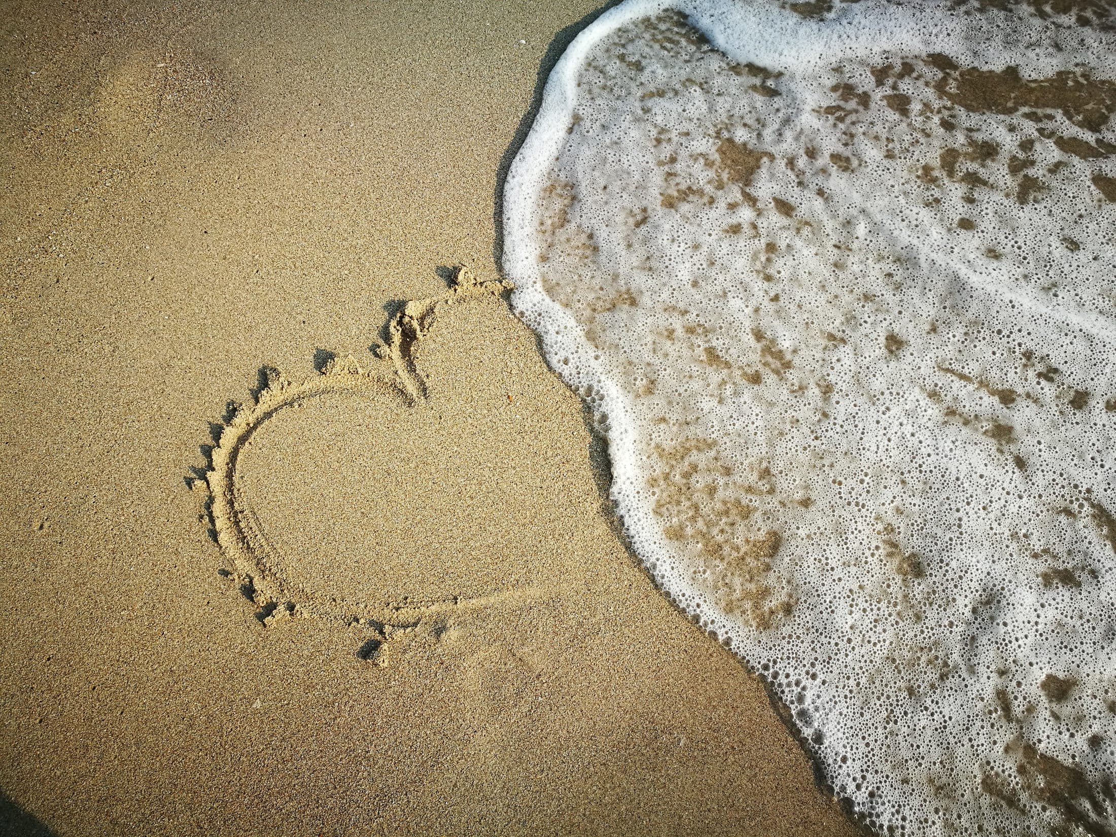 A heart drawn in the wet sand on a Koh Chang beach